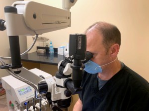 Dr. Lawson using surgical microscope