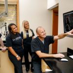Dr. Lawson and staff looking at an x-ray