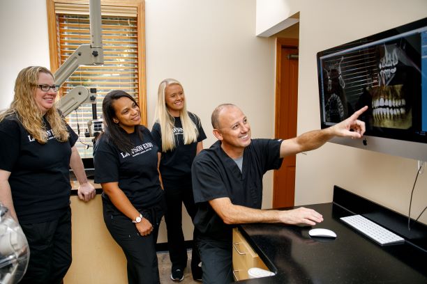 Dr. Lawson and staff looking at an x-ray