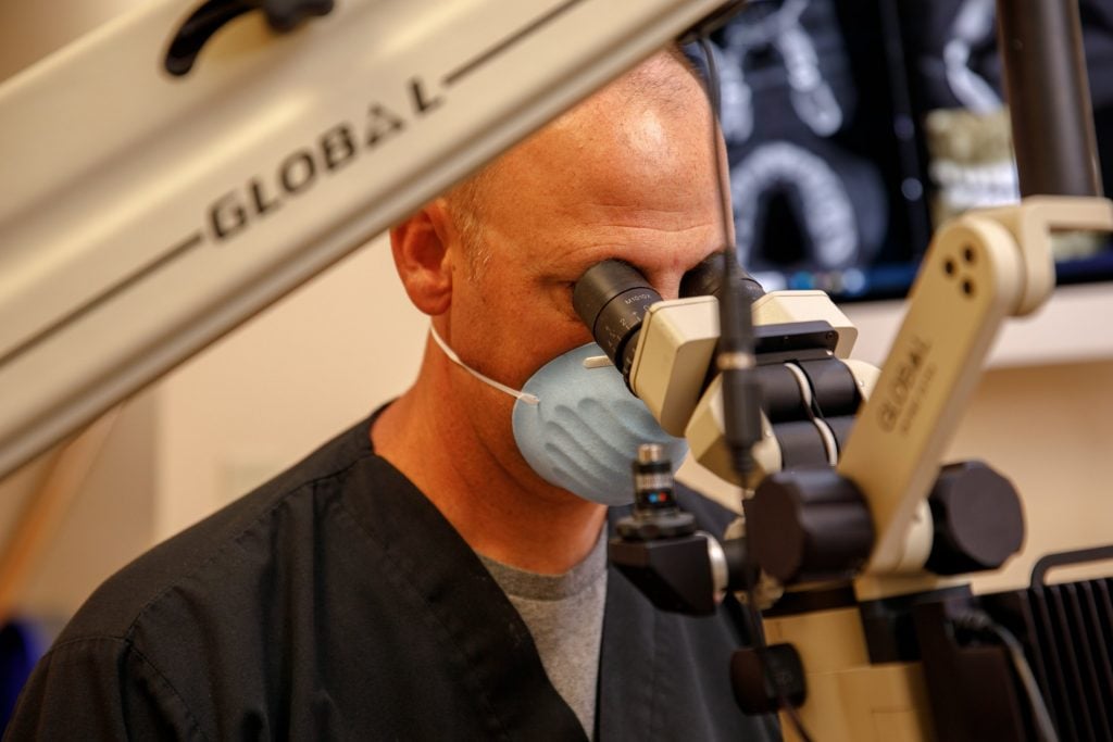 Dr. Lawson using a microscope
