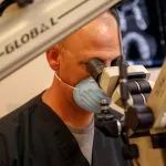 Dr. Lawson using a microscope