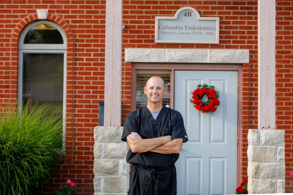 Dr. Lawson smiling outside the front door of the office
